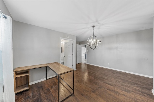 unfurnished dining area with dark hardwood / wood-style floors and an inviting chandelier