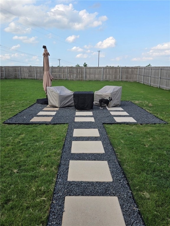 view of yard featuring a patio and a fenced backyard