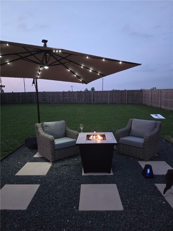 view of patio featuring an outdoor fire pit and a fenced backyard