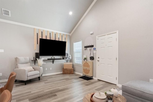 living room with high vaulted ceiling, light wood-style flooring, visible vents, and baseboards