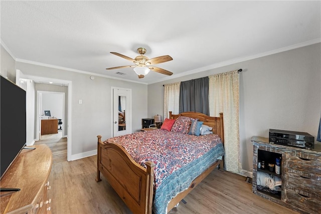 bedroom with light wood finished floors, baseboards, ornamental molding, and ceiling fan