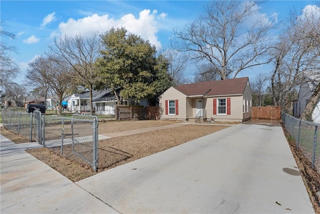 view of front of house with driveway, fence, and a gate