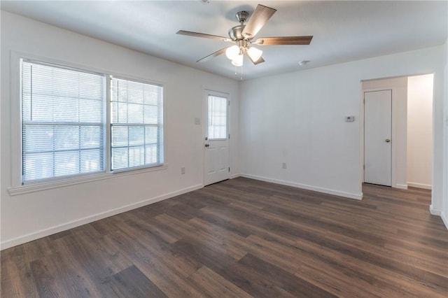 spare room featuring dark hardwood / wood-style floors and ceiling fan