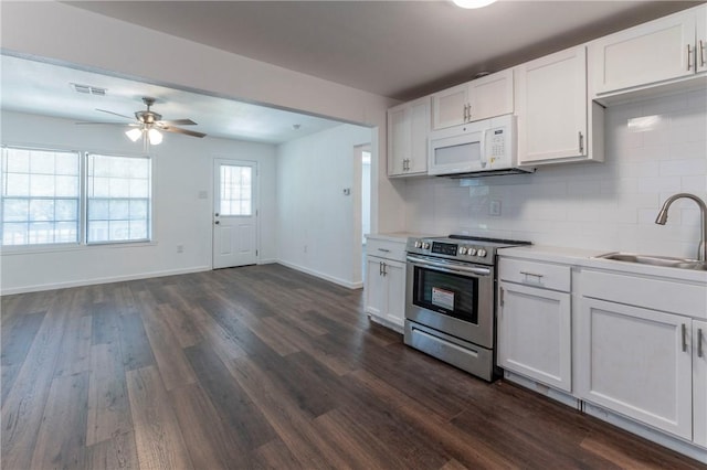 kitchen featuring sink, dark wood-type flooring, stainless steel range with electric cooktop, backsplash, and white cabinets