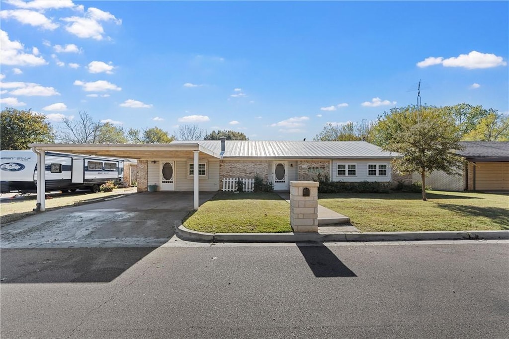 view of front facade with a carport and a front yard