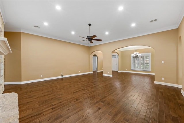 unfurnished living room featuring ceiling fan with notable chandelier, dark hardwood / wood-style flooring, a fireplace, and crown molding