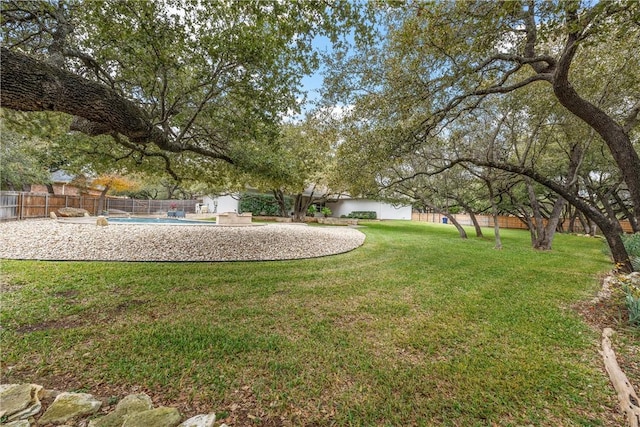 view of yard with a fenced in pool