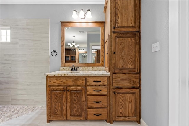 bathroom with vanity and a chandelier