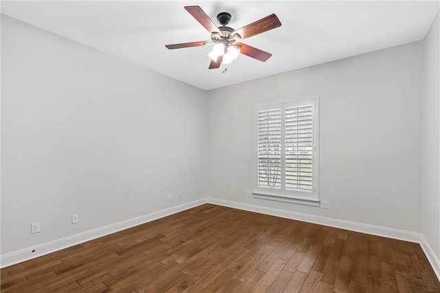 spare room featuring ceiling fan and dark wood-type flooring