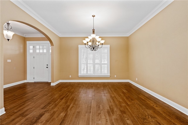 entryway with dark hardwood / wood-style flooring, an inviting chandelier, and ornamental molding