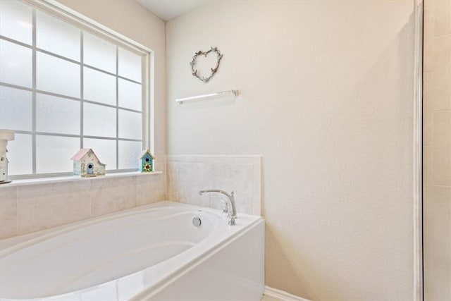 bathroom with a garden tub