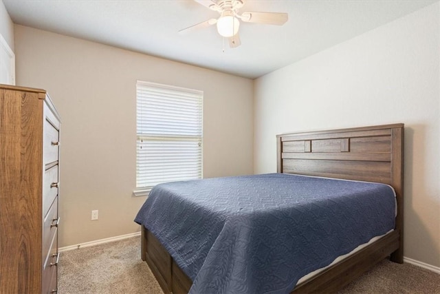 carpeted bedroom with baseboards and a ceiling fan