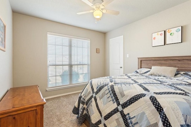 bedroom with a ceiling fan, carpet flooring, and baseboards