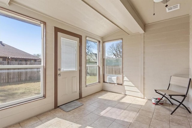 unfurnished sunroom with a healthy amount of sunlight, vaulted ceiling with beams, visible vents, and cooling unit