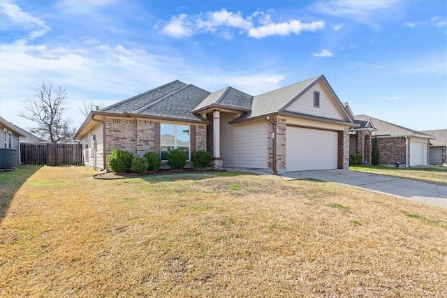 view of front of property featuring brick siding, an attached garage, fence, driveway, and a front lawn