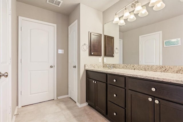 bathroom with visible vents, vanity, and baseboards