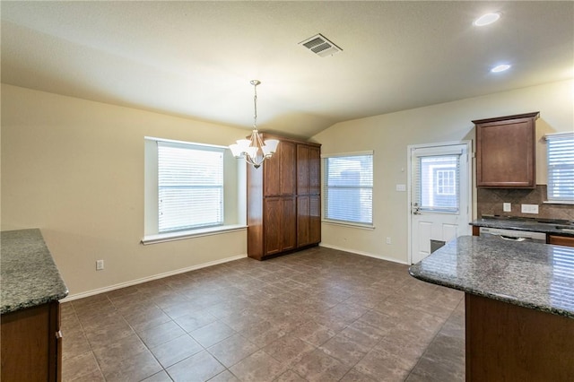 unfurnished dining area featuring lofted ceiling and an inviting chandelier