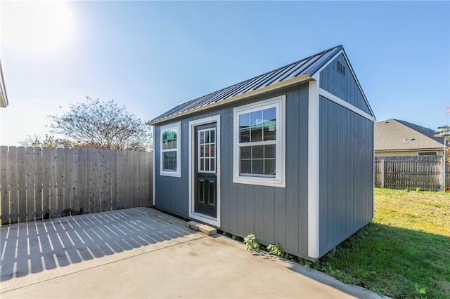 view of outbuilding featuring a lawn