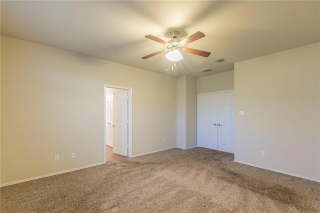 spare room featuring carpet flooring and ceiling fan