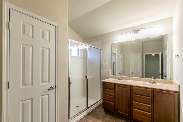 bathroom with tile patterned flooring, vanity, lofted ceiling, and a shower with shower door