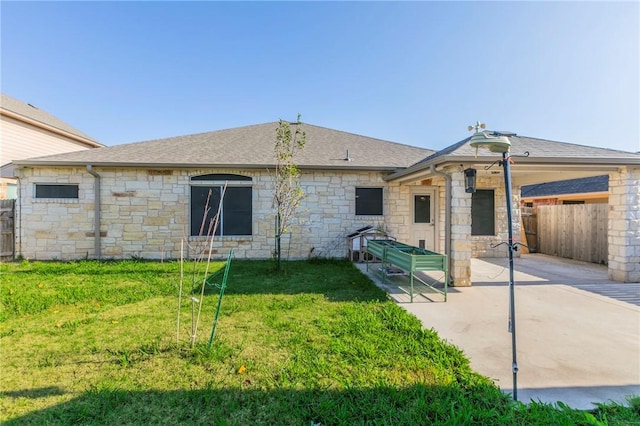 back of property featuring a lawn and a patio