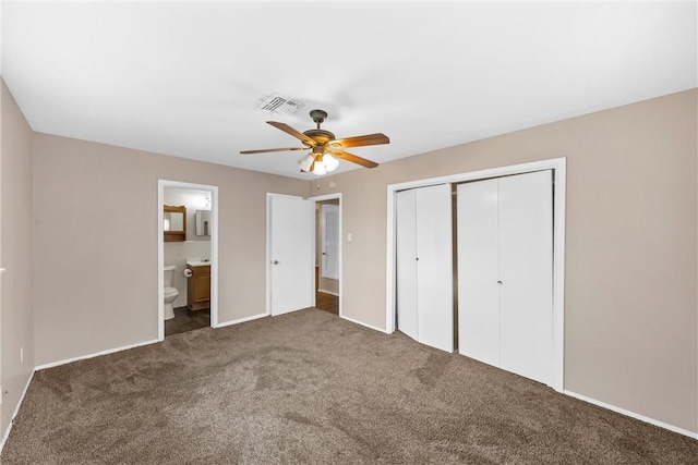 unfurnished bedroom featuring carpet floors, ceiling fan, a closet, and connected bathroom