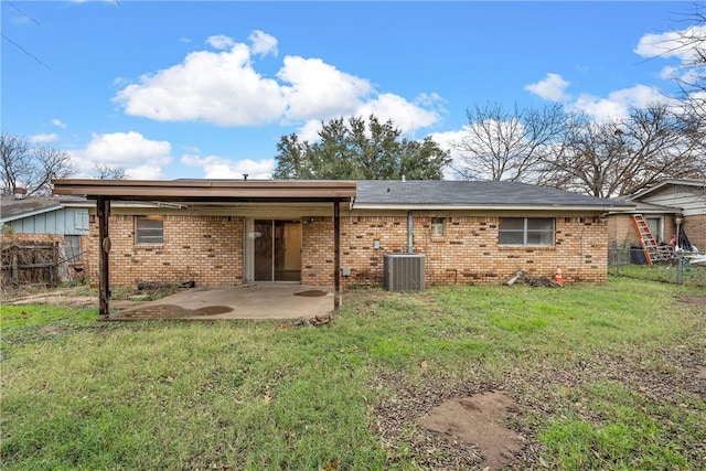 back of property featuring a lawn, central air condition unit, and a patio area