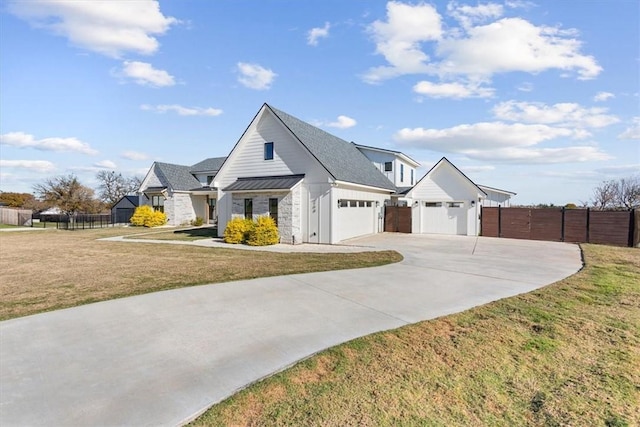 modern inspired farmhouse with a front lawn and a garage