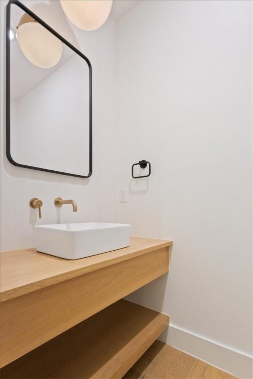 bathroom with hardwood / wood-style flooring and sink