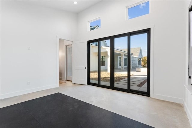 unfurnished room with a towering ceiling