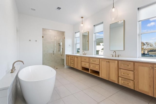 bathroom featuring tile patterned flooring, plenty of natural light, vanity, and shower with separate bathtub