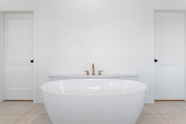 bathroom with tile patterned floors and a bathtub