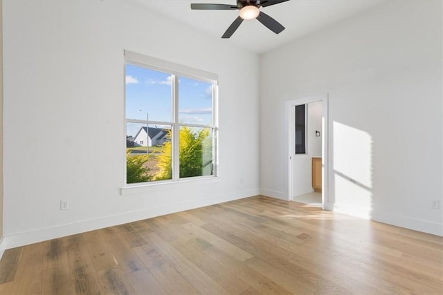 empty room with light wood-type flooring and ceiling fan