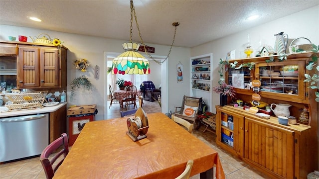 dining space featuring light tile patterned floors, a textured ceiling, and built in features