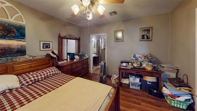 bedroom featuring a textured ceiling, dark hardwood / wood-style floors, ceiling fan, and connected bathroom