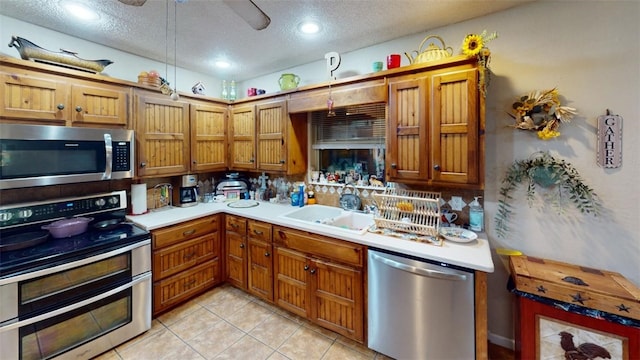 kitchen featuring decorative backsplash, sink, stainless steel appliances, and a textured ceiling