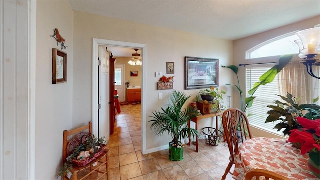 dining area featuring light tile patterned floors and a textured ceiling