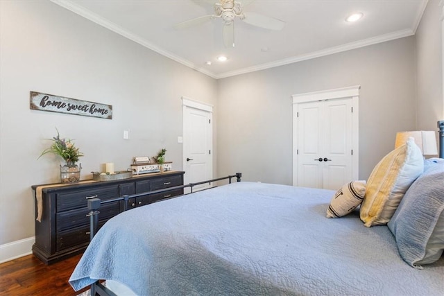 bedroom featuring dark hardwood / wood-style flooring, a closet, ceiling fan, and ornamental molding