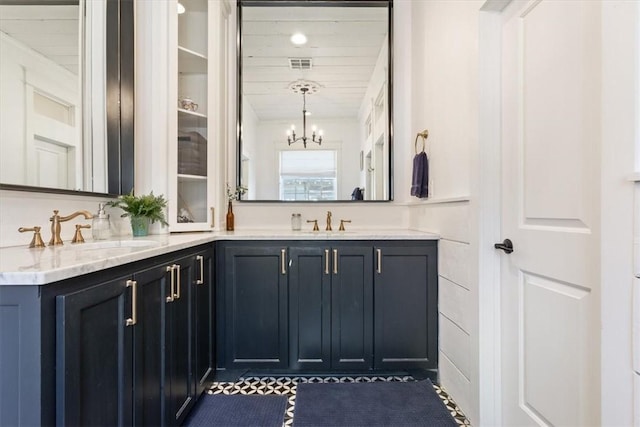 bathroom featuring vanity, an inviting chandelier, and wooden ceiling