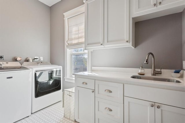 laundry room featuring cabinets, sink, and washing machine and clothes dryer