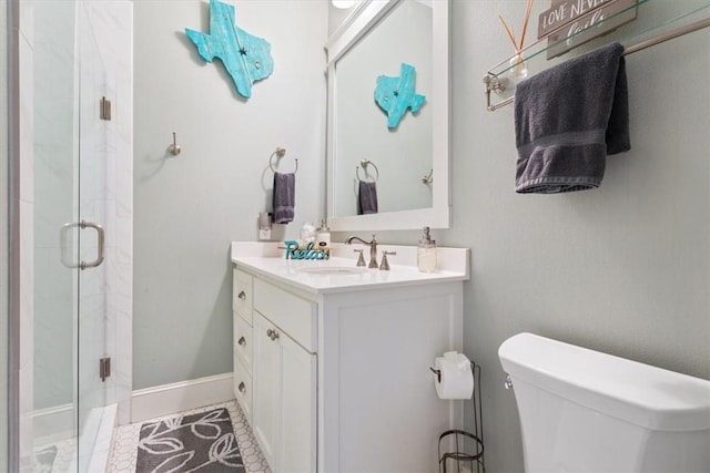 bathroom featuring vanity, toilet, and walk in shower