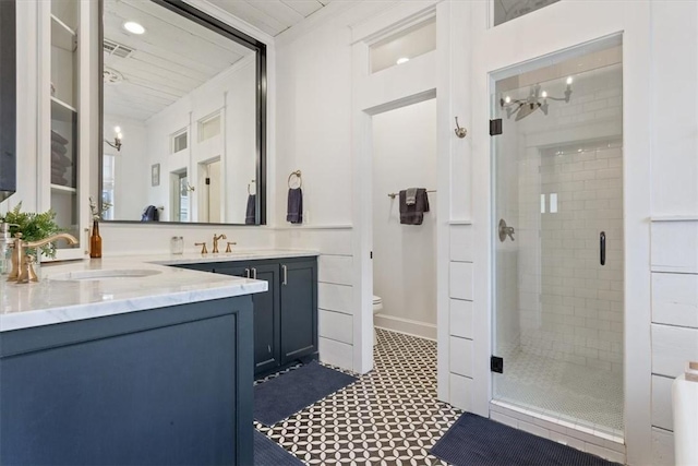 bathroom with an enclosed shower, vanity, and toilet