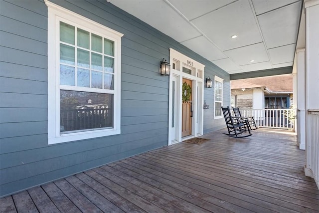 wooden terrace featuring covered porch