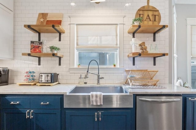 kitchen featuring blue cabinetry, decorative backsplash, and stainless steel dishwasher