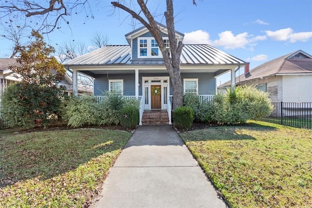 bungalow with a porch and a front lawn