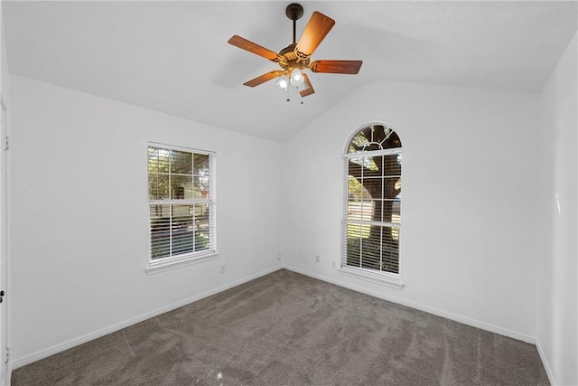 carpeted empty room with ceiling fan and vaulted ceiling