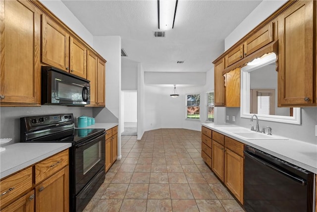 kitchen featuring light tile patterned floors, sink, and black appliances