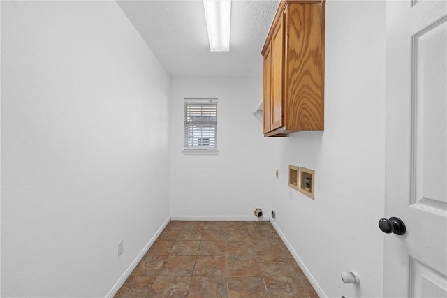 laundry room with hookup for a gas dryer, cabinets, a textured ceiling, and hookup for a washing machine