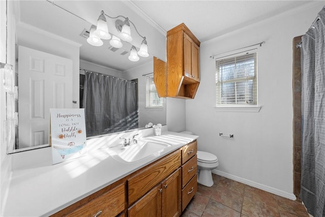 bathroom featuring vanity, toilet, plenty of natural light, and crown molding