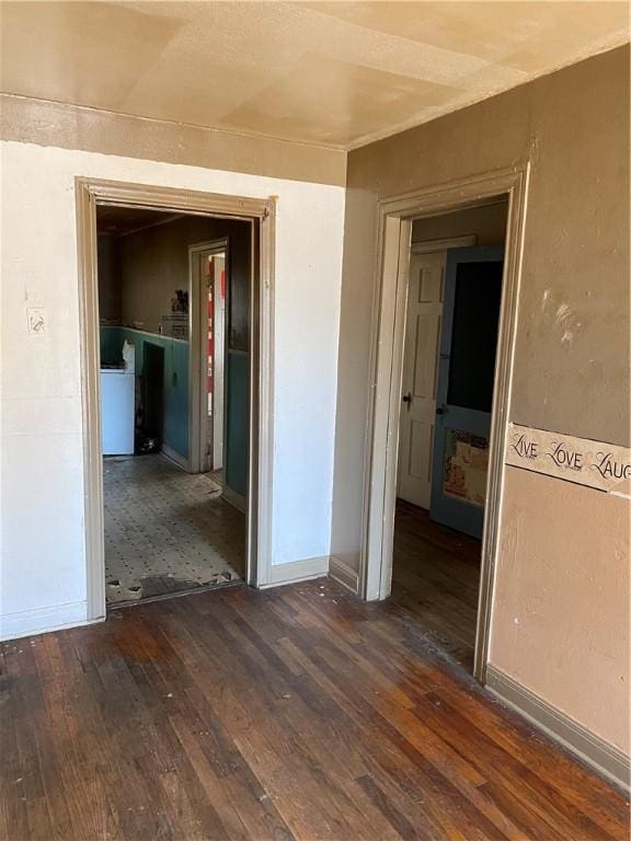 empty room featuring washer / dryer and dark hardwood / wood-style floors